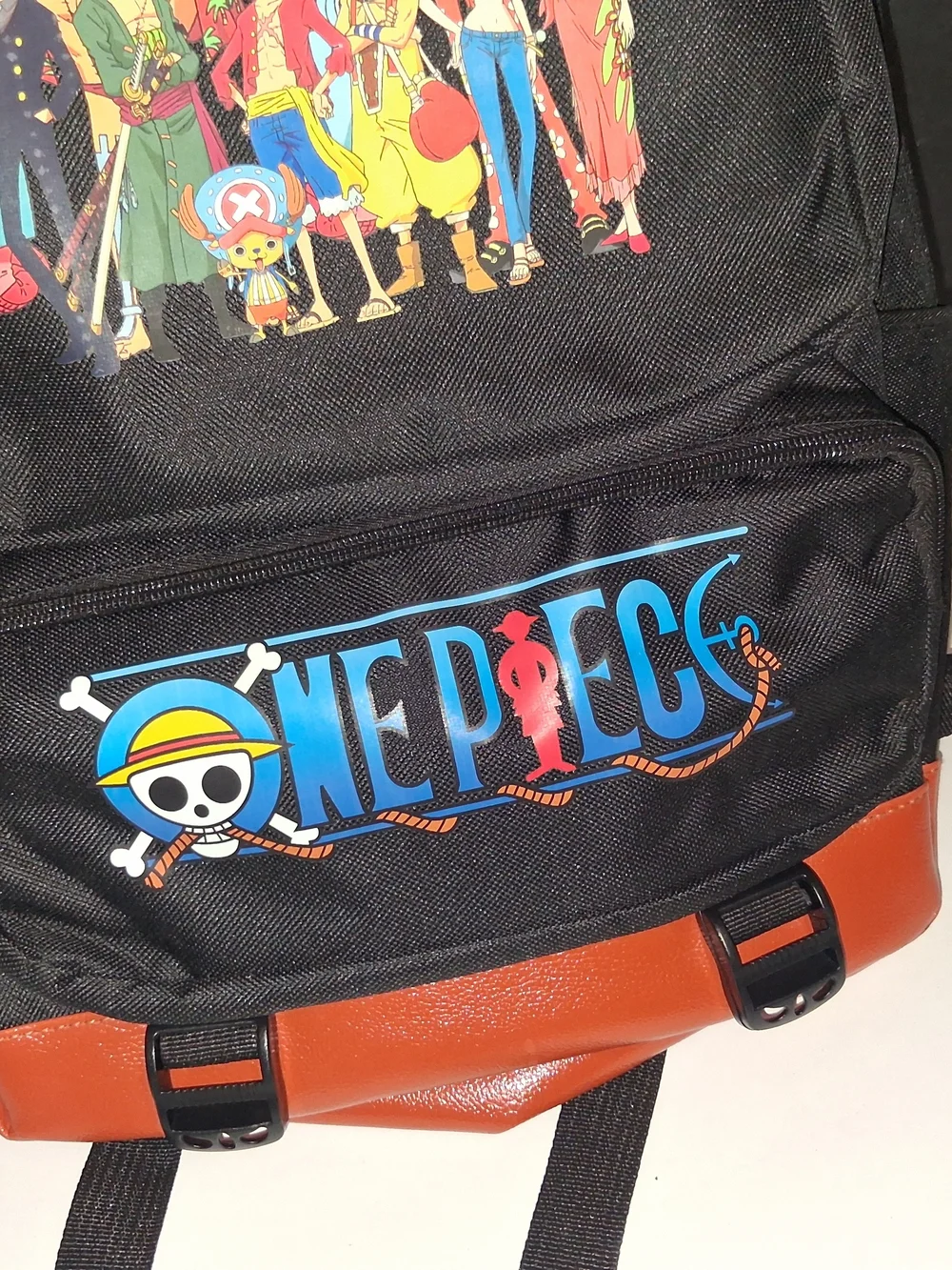 Onepiece Black Backpack with Brown Trim and Colorful Crew Print